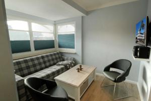 a living room with a couch and a table and chairs at Deutsches Haus by Rujana in Binz