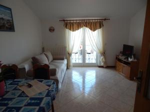 a living room with a couch and a table at MARILENA in Fažana