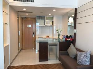 a kitchen and living room with a counter and a couch at Ramada Hong Kong Grand View in Hong Kong