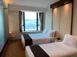 Postelja oz. postelje v sobi nastanitve Ramada Hong Kong Grand View
