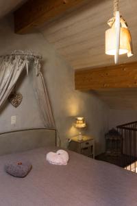 a bedroom with a bed with a canopy and a lamp at Gîte de Corbion in Leignon