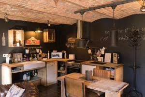 a kitchen with a counter and a table in it at Gîte de Corbion Loft1 in Ciney