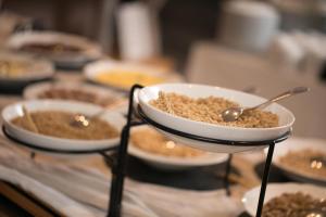 a table topped with plates of food with bowls of food at Aktaion Resort in Gythio