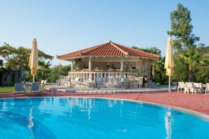 a swimming pool with a gazebo and a resort at Aktaion Resort in Gythio