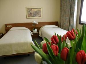 Postel nebo postele na pokoji v ubytování Hotel Villa Monica