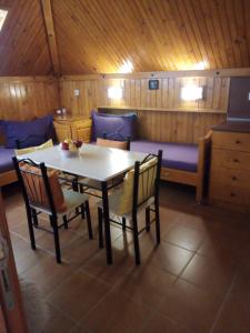 a dining room with a table and chairs and a couch at Doctor's House in Sinemorets +25 photos