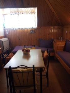 a dining room with a table and a couch at Doctor's House in Sinemorets