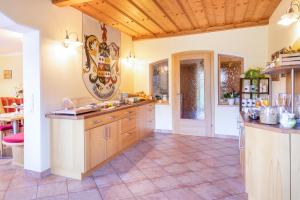 a large kitchen with wooden cabinets and a tile floor at Wechslerhof in Flachau