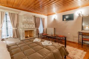 a large bed in a room with a fireplace at Guesthouse Selini in Vitsa