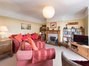 a living room with a couch and a fireplace at Glan Y Mor, 147 Station Road in Deganwy