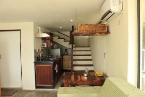 a kitchen with a staircase and a table in a room at Kayube Boat House in Livingstone