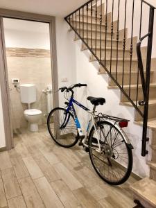 a bike parked in a bathroom next to a staircase at Casa Sophy in Chioggia