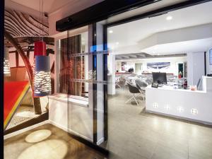 an office with a glass door leading into a room at Hôtel Gustave Colmar in Colmar +28 photos