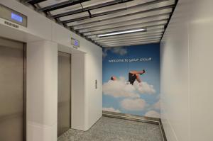 a hallway with a mural of a person in the clouds at MY CLOUD Transit Hotel - Guests with international flight only! in Frankfurt