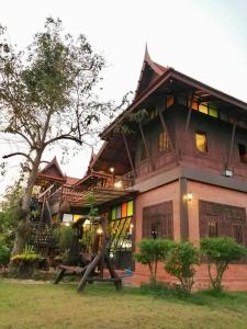 a large house with a large staircase in front of it at Rueanrubkwan in Ang Thong