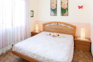 a bedroom with a bed with two dolls on it at Eveten Apartments - Diano Marina in Diano Marina