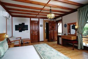 a bedroom with a bed and a desk in a room at Zakros Hotel Lykia in Faralya