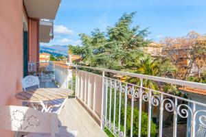 a balcony with a table and chairs and a view at Eveten Apartments - Diano Marina in Diano Marina