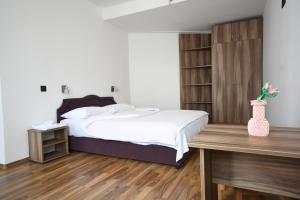 a bedroom with a bed and a wooden desk at Hotel Mladost in Tjentište +54 photos