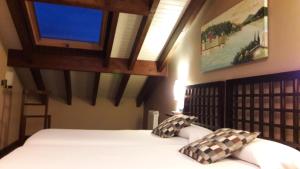 um quarto com uma cama e uma televisão na parede em La Casona de Palu em Pola de Laviana