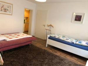 a bedroom with two beds and a door to a kitchen at City Apartment in Nürnberg Center in Nuremberg