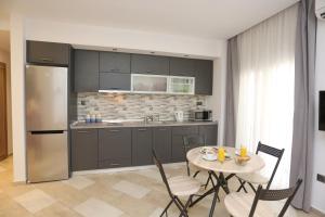 a kitchen with a table and chairs and a refrigerator at Santa Sofia City Center in Thessaloniki
