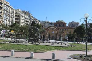 a group of pigeons in a park in a city at Santa Sofia City Center in Thessaloniki