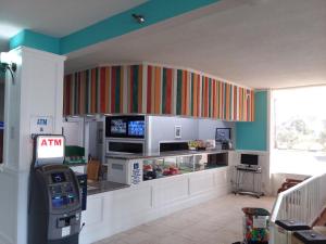 a kitchen with a microwave, refrigerator, sink, and dishwasher at Fountain Beach Resort - Daytona Beach in Daytona Beach