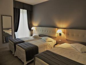 Posteľ alebo postele v izbe v ubytovaní Hotel Accursio