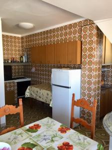 a kitchen with a white refrigerator in a room at Appartamenti Maria in Gabicce Mare