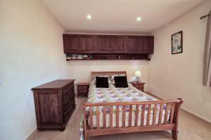 a bedroom with a bed and a wooden cabinet at Los Arcos, Javea in Jesus Pobre +37 photos