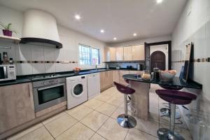 a large kitchen with a counter and a dishwasher at Los Arcos, Javea in Jesus Pobre