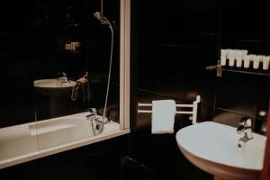 a bathroom with a sink and a tub and a toilet at Hôtel Cecyl Reims Centre in Reims +72 photos