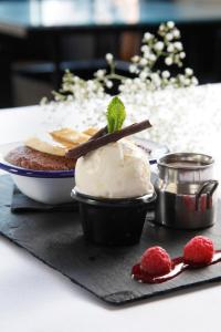 a table with a dessert with ice cream on a table at The Peacock in Bakewell