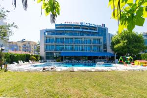 a hotel with a swimming pool in front of a building at Regata Palace Hotel in Sunny Beach