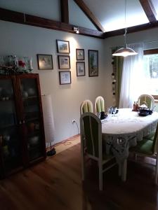 a dining room with a white table and chairs at Uroczysko Ludwinowo na Podlasiu in Łuka