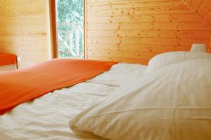 a white bed in a room with a window at Klara in Sarbinowo