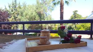 a table with a vase and flowers on a table at Cozy summer house by the beach in Fourka +4 photos