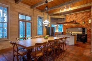 a large kitchen with a wooden table and chairs at Birdwood Estate in Wilyabrup