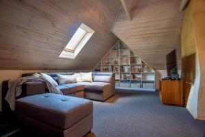 a attic living room with a couch and a tv at Birdwood Estate in Wilyabrup