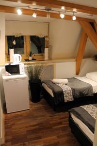 a room with two beds and a microwave in it at Central sweet BNB in Amsterdam