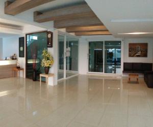 a lobby with a large white tile floor and windows at DD Boutique Resort in Ban Wat Pa