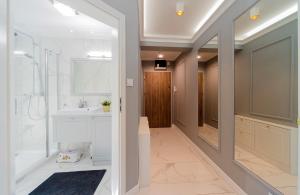a bathroom with a shower and a sink and a mirror at Sea Apartment Leśne Tarasy in Dziwnówek +13 photos