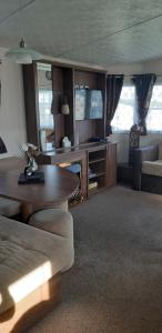 a living room with a couch and a table at crimdon dene holiday park in Hartlepool