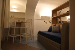 a bedroom with a bunk bed and a table and chairs at Arco della Rua in Amalfi