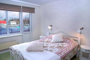 a bedroom with a bed with two pillows on it at Nameja Apartments in Jēkabpils