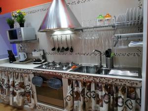 a kitchen with a sink and a stove at Red House in Naples