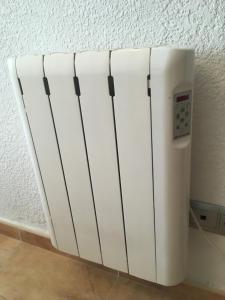 a white refrigerator is next to a wall at Apartamento en Alicante, Plaza de España, zona Mercado, AA in Alicante