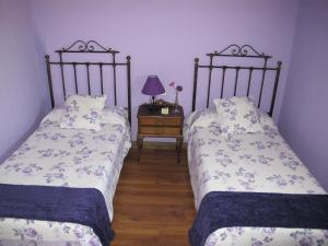 A bed or beds in a room at Albergue San Pelayo