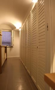 a hallway with white closets and a window at Arco della Rua in Amalfi